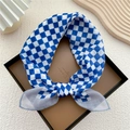Blue and white checkered cotton linen scarf tied in a bow on a leather tray - Deep Blue Two-Tone Gingham
