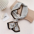 Narrow silk scarf with black geometric pattern and orange borders on wooden tray - Black Border C Print