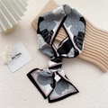 Fashionable twilly scarf with black and white floral prints and red border on wood panel - Red Frame Floral (Camellia)