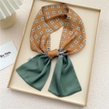 Caramel and green patchwork silk scarf tie featuring geometric prints on a gold tray - Green Plaid Darts (16X)