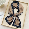 Floral print long silk scarf in earth tones with black trim displayed on a tray - Black Dianthus Frame (5X)