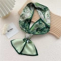 Green paisley silk neck scarf for women featuring bohemian floral pattern tied in a knot - Four-Leaf Heart Green