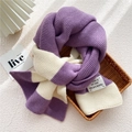 Knitted winter scarf featuring purple and cream stripes in a cozy woven tray display - Purple White Striped