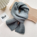 Deep grey knitted winter scarf with a brown logo patch, presented on a wooden tray - 18*155cm / Medium Grey