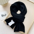 Chic black knitted scarf in a vertical ribbed design with a white care label on top - 22x150cm / Black