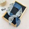 Blue floral and polka dot skinny silk scarf tied on a gold frame for styling - Small Spot Blue