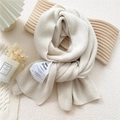 Creamy beige knitted scarf with minimalist fabric patch label for winter warmth - Off-white (MARI Tag)