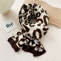 Thick knitted leopard print scarf in brown and white with ribbed edges and soft texture - Brown Leopard Print