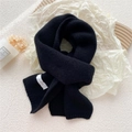 Minimalist black knitted scarf for women featuring a stylish white stitched FEIDING label - Black