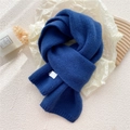 Thick navy blue knitted scarf with ribbed edge and small white tag on textured paper - Dark Blue