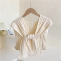 Knitted cable-knit shawl wrap in cream white with a stylish front knot and wavy edges - Beige