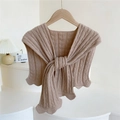 Chic beige knitted shawl with knotted front and scalloped edges on a wooden hanger - Oatmeal