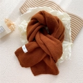 Thick knit winter scarf in caramel brown color with a minimalist white brand label - Caramel color
