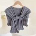 Dark grey knitted shawl with cable knit pattern and scalloped edges on a wooden hanger - Gray