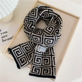 Thick knit scarf with black and beige geometric patterns and branded wash label - Black and White Maze