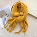 Bright yellow chunky knit scarf with braided tassels for winter warmth and cozy style - Yellow