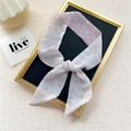 Elegant narrow light pink floral silk scarf tied in a bow on a white textured background - White Epiphyllum Pink