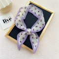 Narrow silk twilly scarf with purple edges and cherry fruit prints on a black board - Tomato Purple