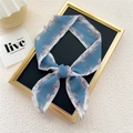 Elegant lake blue narrow silk scarf with floral print tied as a versatile fashion accessory - Flying Feather Blue
