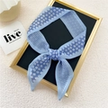 Light blue floral and checkered narrow silk twilly scarf tied in a bow for decoration - Small Floral Grid Blue
