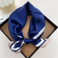 Navy blue silk square scarf with white stripe border tied in a bow in a gift box - Navy Geometric Node (23Z)