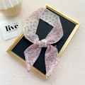 Narrow floral silk scarf with pink and purple blossoms tied in a bow shape - Half Purple Floral
