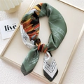 Artistic square silk scarf in bean green with abstract geometric patterns on a tray - 9 Green Pegasus