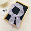 Narrow silk scarf with light purple floral pattern shown on an elegant display stand - Purple Rose Red Flower