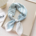 Blue and white diagonal striped silk scarf tied in a bow on a luxury display tray - Long Stripes Blue (16)