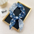 Narrow indigo floral silk scarf tied in a bow with delicate white and pink petals - Dark Blue White Magnolia
