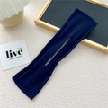 Detail of a dark blue fabric deft bun hair maker tool with center opening slot - Navy Blue