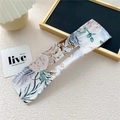 Detailed close-up of a floral print deft bun hair tool with pink roses on white background - Rose Leaf White