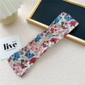 Floral fabric hair bun maker with colorful print on white background for hairstyling - Red Blue Pink White