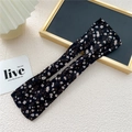 Floral print hair bun maker with inner wire shown in a cozy lifestyle setting - Spiky Floral Black