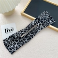 Macro detail of leopard print hair bun maker with inner wire for elegant styling - Gray Leopard