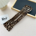 Detail of leopard print hair bun maker showing flexible fabric and hollow structure - Yellow Leopard