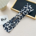 Close-up of leopard print hair bun maker with blue and black patterns on fabric - Leopard Gray