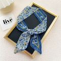Blue floral skinny scarf with white lettering detail tied in a stylish knot - Blue English Floral