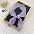 Narrow purple geometric diamond pattern skinny scarf tied on a display board - Purple Diamond Hourglass