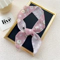 Pink floral skinny silk scarf tied in a bow on a display board for neck or bag - Pink White Magnolia