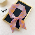 Narrow purple silk scarf with bright orange citrus print tied in a bow on a frame - Rose Purple Orange Fruit