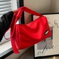 Bright red nylon cloud-style crossbody bag with adjustable strap and logo detail - Red