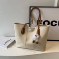 Minimalist cream tote bag with contrast brown straps and plush charm for daily commute - Cream White with Pendant
