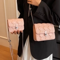 Pink quilted crossbody chain bags for women in medium and small sizes shown on model - Large / Pink