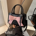 Black glossy handbag with a large pink bow and silver heart buckle detail - Black & Pink