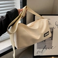 Versatile cream nylon crossbody bag with wide shoulder strap and KERORO label - Off-white