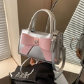Silver leather handbag with pink bow and heart crystal on a mirrored background - Silver