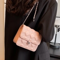 Light pink quilted chain crossbody bag with gold metal clasp shown on model indoors - Small / Black