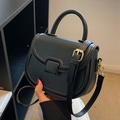 Classic black leather saddle bag with gold hardware and top handle for women - Black