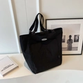 Minimalist black canvas tote bag with large capacity and oval logo for daily commute - Black